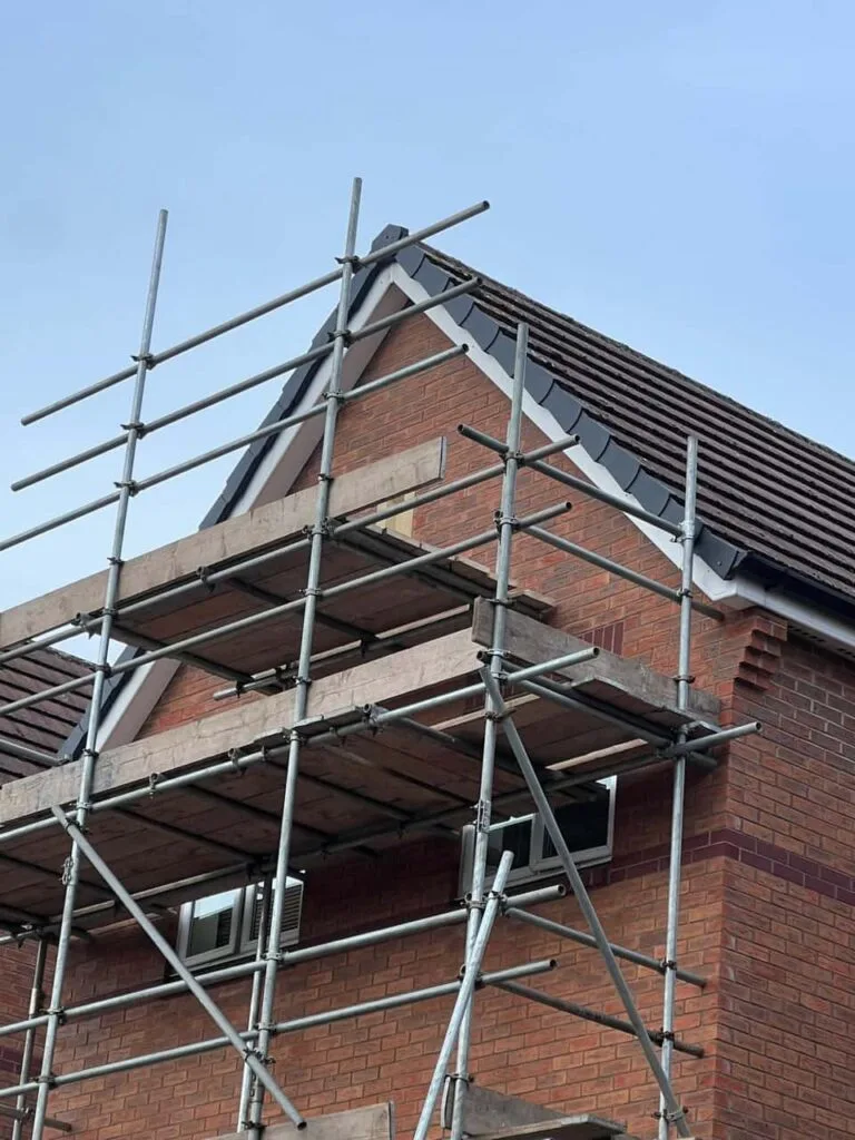 This is a photo of a roof which has just been repaired. There is a scaffold located at the gable end for access onto the roof. Works carried out by Cowplain Roofing Repairs