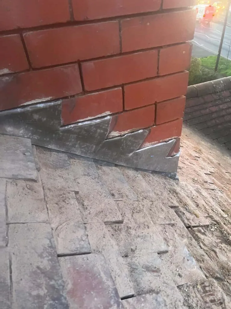 This is a photo of new leadwork being installed around an old chimney. Works carried out by Cowplain Roofing Repairs