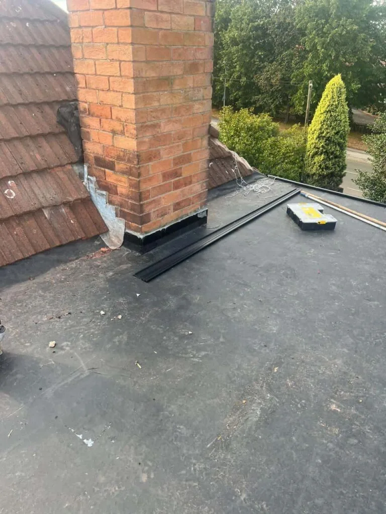 This is a photo of a flat roof which has just been repaired, there is also a chimney stack and some leadwork has also been dressed. Works carried out by Cowplain Roofing Repairs